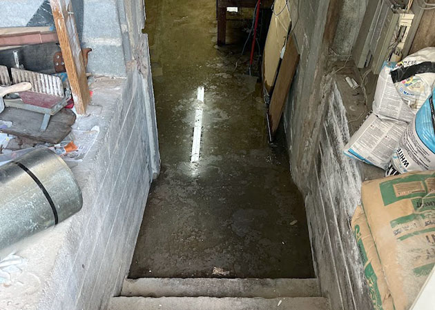 Stairs leading to a flooded basement