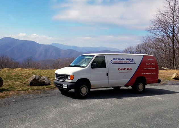 A van with mountains in the background